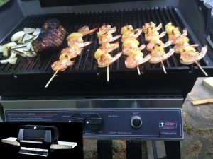 shrimp, steak, vegetables on a grill